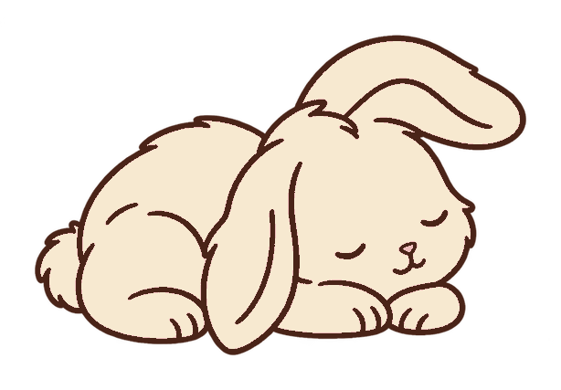 丸くなって眠るクリーム色のウサギ